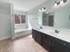 Spacious bathroom with a bathtub, double vanity, and modern fixtures at 6234 N Woods Edge Dr, McCordsville, IN 46055