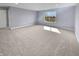 A spacious bedroom bathed in natural light features plush carpeting and a large window overlooking the neighborhood at 6234 N Woods Edge Dr, McCordsville, IN 46055