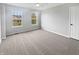 Comfortable bedroom offers plush carpeting, soft gray walls, ceiling fan and view of neighborhood through the windows at 6234 N Woods Edge Dr, McCordsville, IN 46055