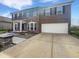 Brick two-story home featuring a two-car garage, a walkway and manicured front lawn at 6234 N Woods Edge Dr, McCordsville, IN 46055