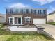 Two-story brick home featuring a two-car garage, a walkway and manicured front lawn at 6234 N Woods Edge Dr, McCordsville, IN 46055