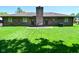 Exterior view of a brick home highlighting a large backyard and patio with a seating area at 6318 Dahlia Dr, Indianapolis, IN 46217