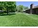 Exterior of brick home with a large backyard, lawn and a patio area at 6318 Dahlia Dr, Indianapolis, IN 46217