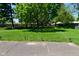 Expansive backyard featuring a lush lawn, mature trees, and subtle landscape lighting at 6318 Dahlia Dr, Indianapolis, IN 46217