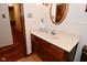 Bathroom vanity featuring a marble countertop, mirror, and natural lighting at 6318 Dahlia Dr, Indianapolis, IN 46217