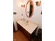Bathroom vanity with marble countertop, decorative mirror and lighting fixtures at 6318 Dahlia Dr, Indianapolis, IN 46217