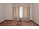 Neutral bedroom featuring a large window with classic curtains and ample natural light at 6318 Dahlia Dr, Indianapolis, IN 46217