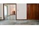 Bedroom features a large closet with mirrored doors, and view into another room at 6318 Dahlia Dr, Indianapolis, IN 46217