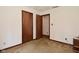 Bedroom with neutral walls, two wooden doors, and carpeted floor at 6318 Dahlia Dr, Indianapolis, IN 46217
