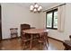 Bright dining area with wood table and chairs, a window, and classic chandelier at 6318 Dahlia Dr, Indianapolis, IN 46217