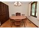 Charming dining area with wood furniture and a view of the outdoors through a bright window at 6318 Dahlia Dr, Indianapolis, IN 46217