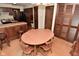 View of an open dining area and kitchen featuring a wood table and cabinetry at 6318 Dahlia Dr, Indianapolis, IN 46217