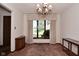 Dining room featuring a large window offering outdoor views and vintage chandelier at 6318 Dahlia Dr, Indianapolis, IN 46217