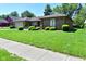 Well-manicured lawn and shrubbery enhance this brick ranch-style home's curb appeal at 6318 Dahlia Dr, Indianapolis, IN 46217