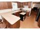 Well-lit kitchen featuring wood cabinetry, an island, and a view into an adjacent living area at 6318 Dahlia Dr, Indianapolis, IN 46217