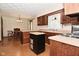 Traditional kitchen with wooden cabinets, laminate counters and a portable island at 6318 Dahlia Dr, Indianapolis, IN 46217