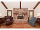 Vaulted living room featuring a brick fireplace, wood accents, and a cozy layout at 6318 Dahlia Dr, Indianapolis, IN 46217