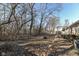 Backyard with a view of a house featuring a deck. Tall trees provide shade at 664 N County Road 800 E, Avon, IN 46123