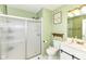 Bathroom showcasing a shower with glass doors, a toilet, and light green walls at 664 N County Road 800 E, Avon, IN 46123