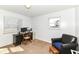 Bedroom featuring neutral carpet, desk, and a comfortable black armchair at 664 N County Road 800 E, Avon, IN 46123