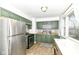 The kitchen features stylish green cabinets, stainless steel appliances, and a window at 664 N County Road 800 E, Avon, IN 46123