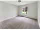 Clean, carpeted bedroom with a large window providing natural light and a view of the outdoors at 6915 Juliet Dr, Avon, IN 46123