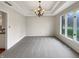 Bright dining room with elegant chandelier, neutral carpeting, and large windows offering natural light at 6915 Juliet Dr, Avon, IN 46123