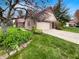 Suburban home with a long driveway, attached garage, and well-maintained landscaping at 6915 Juliet Dr, Avon, IN 46123