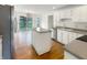 Bright kitchen with white cabinets, a stainless steel refrigerator, and sliding glass doors to the backyard at 6915 Juliet Dr, Avon, IN 46123