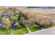 Aerial view of homes with mature trees, and well-manicured lawns near a highway and farm field at 7008 E Jackson St, Muncie, IN 47303