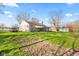 View of backyard showing exterior of home and large lawn at 7008 E Jackson St, Muncie, IN 47303