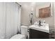 Well-maintained bathroom featuring a toilet, vanity, and mirror at 7008 E Jackson St, Muncie, IN 47303