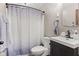 Well-maintained bathroom with a toilet, vanity, and patterned shower curtain at 7008 E Jackson St, Muncie, IN 47303