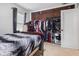 Bedroom with a closet filled with clothes and shelves at 7008 E Jackson St, Muncie, IN 47303