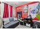 Cozy bedroom features comfortable seating, gaming decor, and a warm, inviting atmosphere at 7008 E Jackson St, Muncie, IN 47303