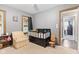 Bedroom featuring a crib and comfortable chair at 7008 E Jackson St, Muncie, IN 47303