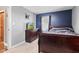 Relaxing bedroom showcasing a bed, dresser, and mounted TV at 7008 E Jackson St, Muncie, IN 47303