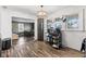 Open dining area with hardwood flooring, large windows, and modern chandelier lighting at 7008 E Jackson St, Muncie, IN 47303