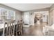 The dining room features hardwood floors, a dining table with seating, and views into the kitchen at 7008 E Jackson St, Muncie, IN 47303