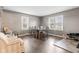 The dining room features hardwood floors, a dining table with seating, and large windows at 7008 E Jackson St, Muncie, IN 47303