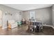 The dining room features dark hardwood floors, a dining table and chairs, and neutral wall paint at 7008 E Jackson St, Muncie, IN 47303