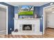 Living room highlighting the fireplace and wall-mounted television at 7008 E Jackson St, Muncie, IN 47303