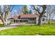 Charming single-story home with a stone facade, inviting porch, and lush lawn at 7008 E Jackson St, Muncie, IN 47303