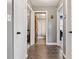 Hallway features hardwood floors and doors to the bedrooms and bathroom at 7008 E Jackson St, Muncie, IN 47303
