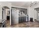 Open kitchen features stainless steel appliances, gray cabinets, and modern flooring at 7008 E Jackson St, Muncie, IN 47303