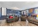 Spacious living room with laminate flooring and comfortable upholstered seating at 7008 E Jackson St, Muncie, IN 47303