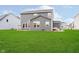 Large backyard with green grass and views of the neighboring houses at 7158 Sugar Maple Ln, Brownsburg, IN 46112