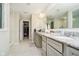 Bright bathroom with double sinks, granite countertop, walk-in closet, and marble floors at 7158 Sugar Maple Ln, Brownsburg, IN 46112