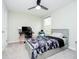 This bedroom includes a grey bed frame, ceiling fan, desk, chair, and window at 7158 Sugar Maple Ln, Brownsburg, IN 46112