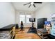 Versatile room with exercise equipment, wood flooring, and a modern ceiling fan at 7158 Sugar Maple Ln, Brownsburg, IN 46112